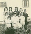 Back Row: Elaine (oldest one), Irene, Eunie, Lola, and Ole Next Row: Mary, Grandma (holding David) & Bev, Jean (Pearl) is the youngest one standing